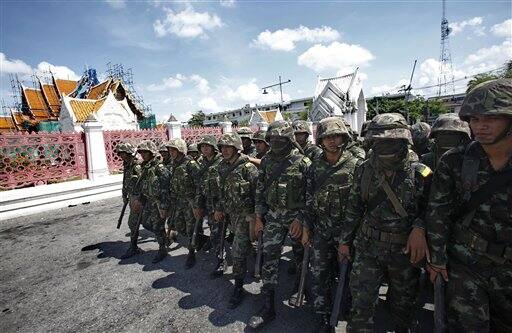 Thai soldiers stand guard outside government house on, in Bangkok, Thailand. Leaders of demonstrations that plunged the Thai capital into chaos Tuesday called off their protests