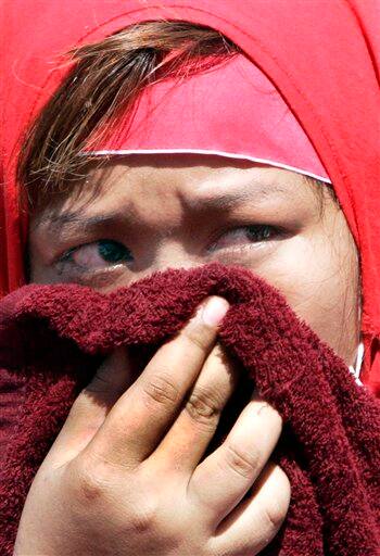 An anti-government protester cries outside Government House in Bangkok, Thailand. Leaders of demonstrations that plunged the Thai capital into chaos Tuesday called off their protests following rioting and clashes