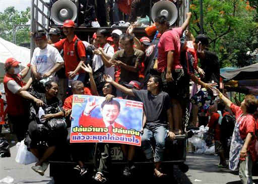 Anti-government protesters and supporters of ousted Prime Minister Thaksin Shinawatra leave the protest venue on a truck with a portrait of Thaksin after their leaders surrendered ending the nearly two-week anti-government protest in Bangkok, Thailand.