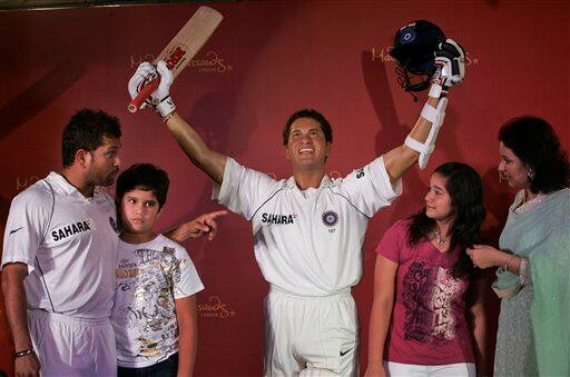 Indian cricket player Sachin Tendulkar, son Arjun, daughter Sara and wife Anjali pose next to Sachin`s wax figure, center, in Mumbai, India, Monday, April 13, 2009.