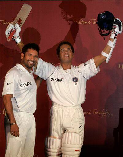 Indian cricket player Sachin Tendulkar, left, poses next to his wax figure in Mumbai, India, Monday, April 13, 2009.