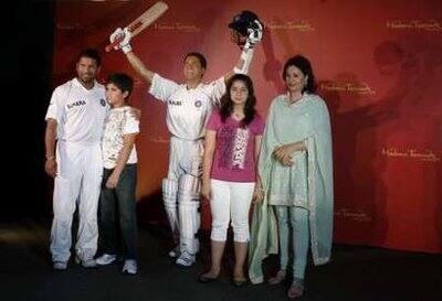 Indian cricketer Sachin Tendulkar (L), his son Arjun, daughter Sara and wife Anjali (R) pose with Sachin`s new wax statue made by Madame Tussauds London museum, during its unveiling in Mumbai April 13, 2009.