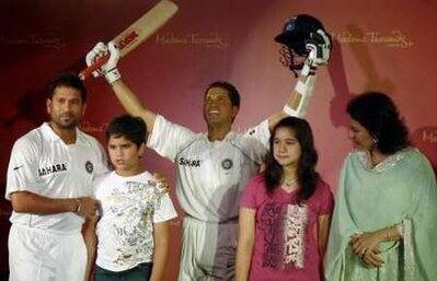 Indian cricketer Sachin Tendulkar (L), his son Arjun, daughter Sara and wife Anjali (R) pose with Sachin`s new wax statue made by Madame Tussauds London museum, during its unveiling in Mumbai April 13, 2009.