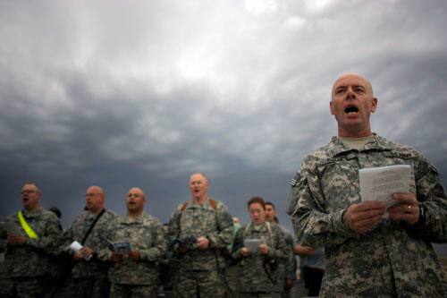 U.S. army soldiers sing hymns during Easter sunrise service in Camp Liberty, Baghdad, Iraq, Sunday, April 12, 2009.