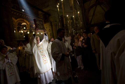 Catholic pilgrims and clergymen participate the Easter mass in the Church of the Holy Sepulchre in Jerusalem`s Old City, Sunday, April 12, 2009.