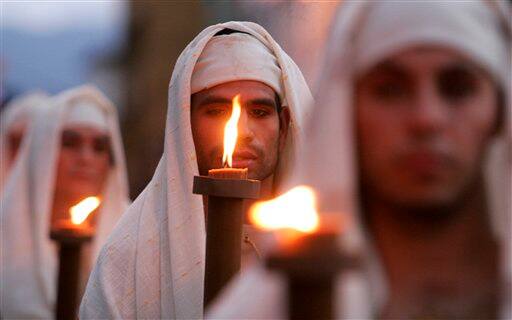 Faithful, carrying candles, take part in a procession during Holy Week in San Jose. Holy Week commemorates the last week of the earthly life of Jesus Christ culminating in his crucifixion on Good Friday and his resurrection on Easter.