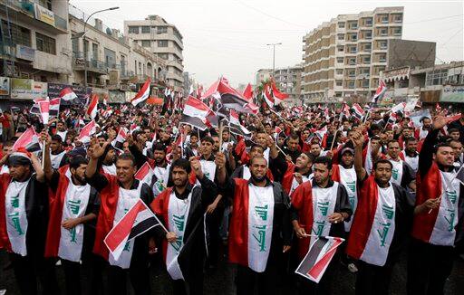 Supporters of anti-U.S. Shiite cleric Muqtada al-Sadr gather in central Baghdad, Iraq, for a rally marking the sixth anniversary of the fall of the Iraqi capital to American troops