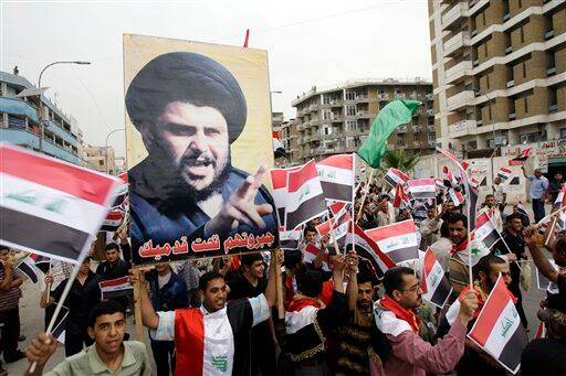 Supporters of anti-U.S. Shiite cleric Muqtada al-Sadr, seen in poster, gather in central Baghdad, Iraq, for a rally marking the sixth anniversary of the fall of the Iraqi capital to American troops.