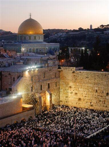 Back-dropped by the Dome of the Rock Mosque, in the Al Aqsa Mosque compound, also known to Jews as the Temple Mount, Jewish worshipers participate in the special 