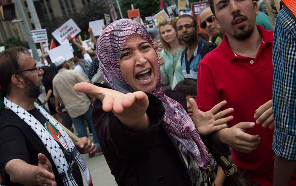 A Palestinian supporter yells at opposing Israeli supporters as hundreds protest the war between Israel and Hamas members in the Gaza Strip in Toronto.