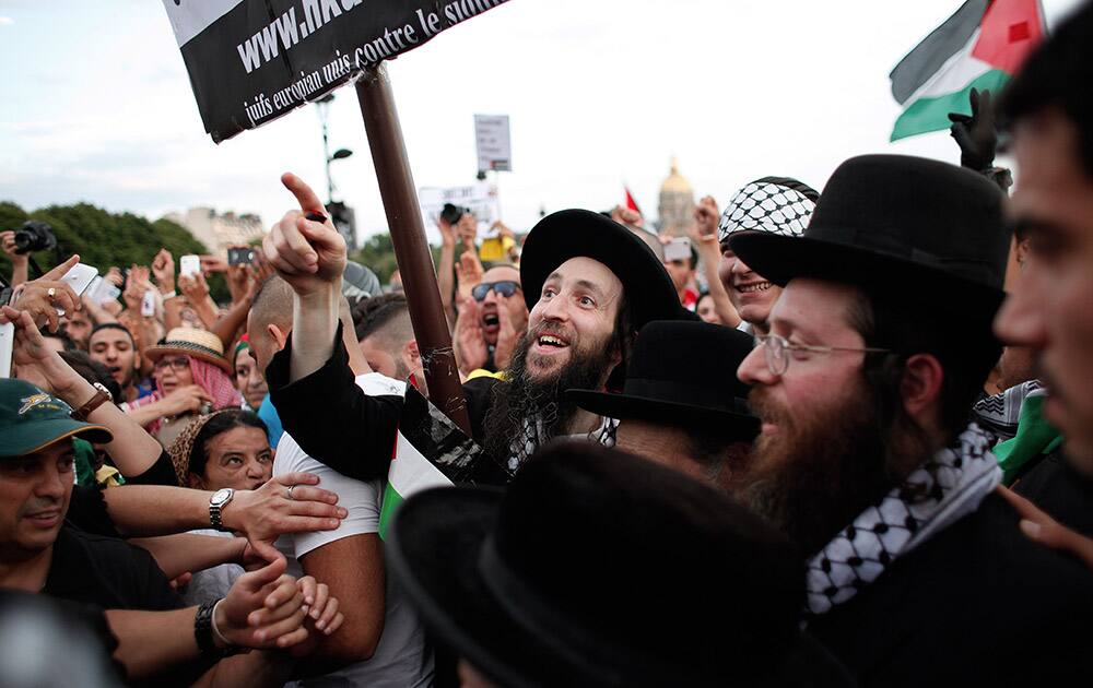 Members of the Ultra-Orthodox Jewish Neturei Karta, a group that opposes Zionism and the Israeli state, protest against the Israeli army`s bombings in the Gaza strip in Paris, France.