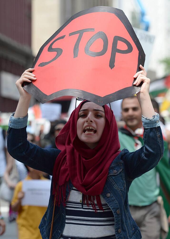 Demonstrators protest in Ottawa against the ongoing war between Israel and Hamas militants who control Gaza, calling for Canada to defend human rights for Palestinians. 