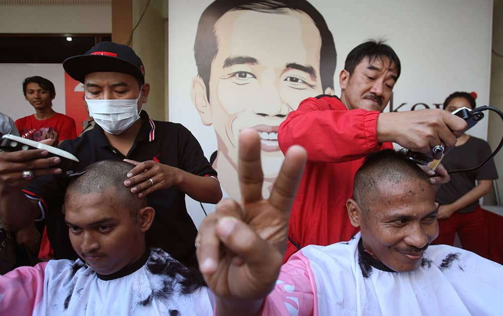 Supporters of Indonesian presidential candidate Joko Widodo cut their hair to celebrate in Surabaya, East Java, Indonesia. Jakarta governor Joko Widodo, who captured the hearts of millions of Indonesians with his common man image, won the country`s presidential election with 53 percent of the vote.