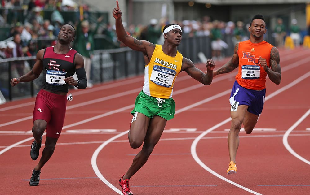 Baylor`s Trayvon Bromell, center, celebrates after winning the men`s 100 meters while Florida State`s Dentarius Locke, left, and Northwestern State`s Justin Walker, right, follow at the NCAA track and field championships, in Eugene, Ore. 