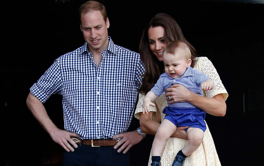 File Photo- Britain`s Prince William, Kate Duchess of Cambridge and Prince George. Today is baby Prince George`s first birthday.