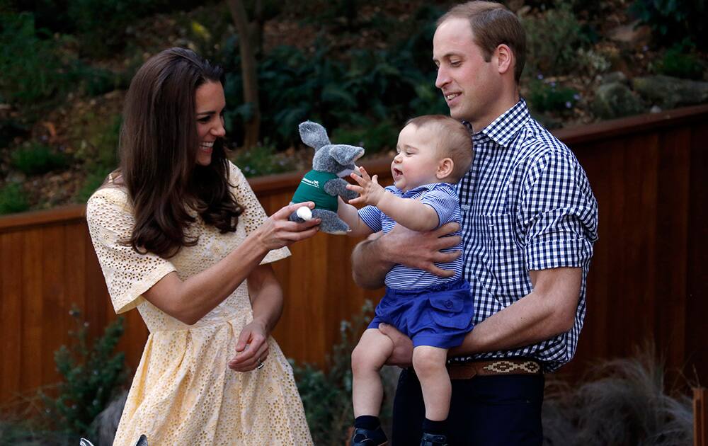 File Photo- Britain`s Prince William, Kate Duchess of Cambridge and Prince George. Today is baby Prince George`s first birthday.