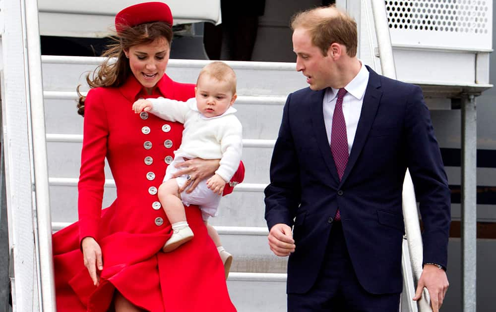 File Photo- Britain`s Prince William, Kate Duchess of Cambridge and Prince George. Today is baby Prince George`s first birthday.