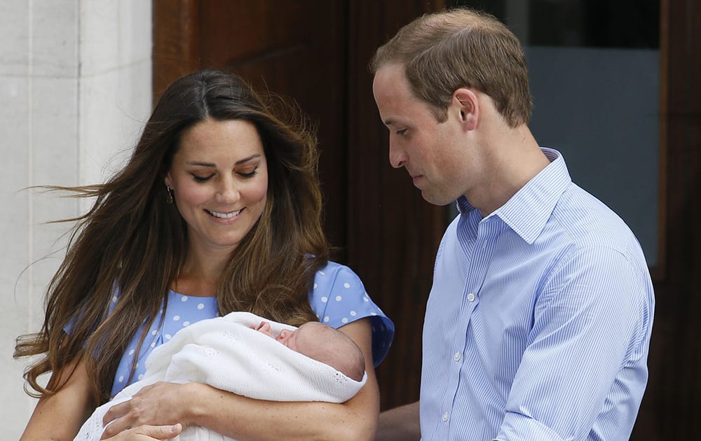 File Photo- Britain`s Prince William, Kate Duchess of Cambridge and Prince George. Today is baby Prince George`s first birthday.