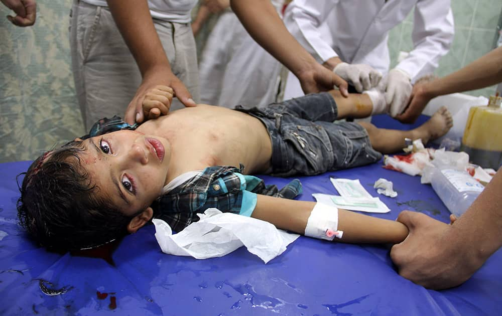 Palestinian medics treat a wounded boy following an Israeli air strike on a family house, at a treatment room of al Najar hospital in Rafah, in the southern Gaza Strip.