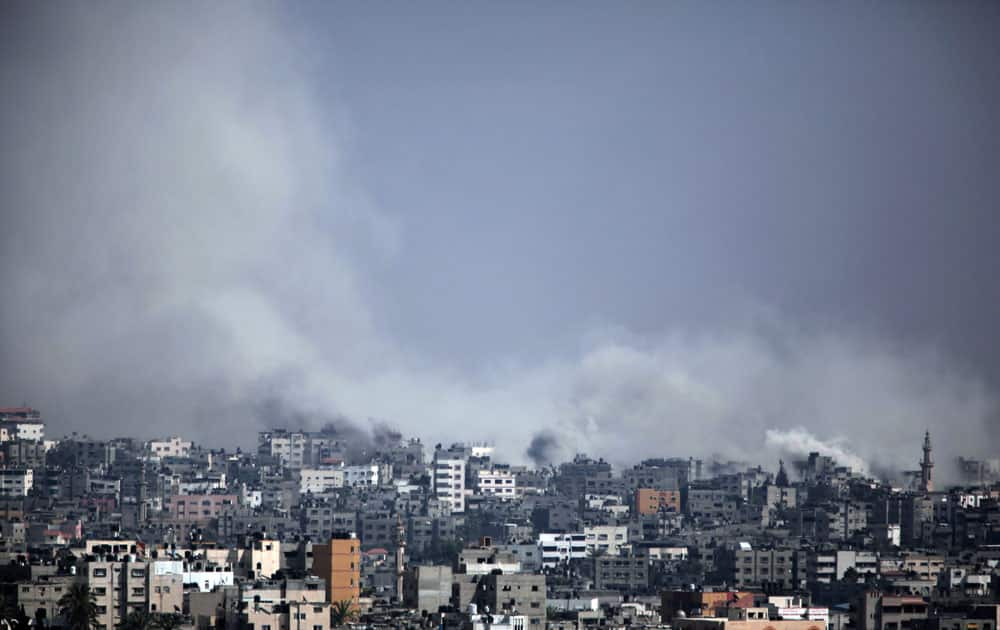 Smoke rises after an Israeli shell hit at Shijaiyah neighborhood, Gaza City.