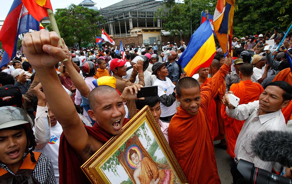 Cambodian Buddhist monks shout slogans during a rally in front of Vietnamese Embassy in Phnom Penh, Cambodia.