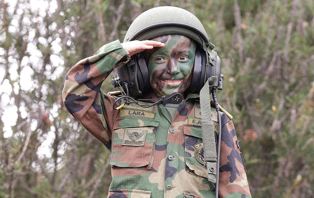 A boy wearing a military uniform poses for a photo during a military parade marking Colombia`s 204 anniversary of independence from Spain, in Bogota, Colombia.