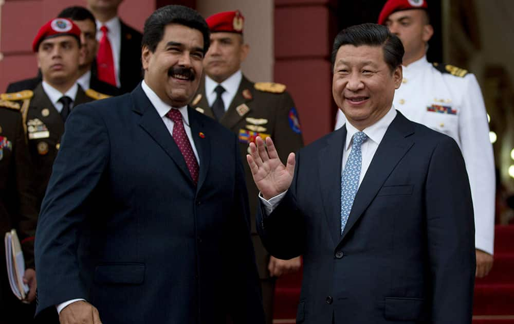 Venezuela`s President Nicolas Maduro, left, jokes with China`s President Xi Jinping prior their meeting at Miraflores Presidential palace in Caracas, Venezuela.