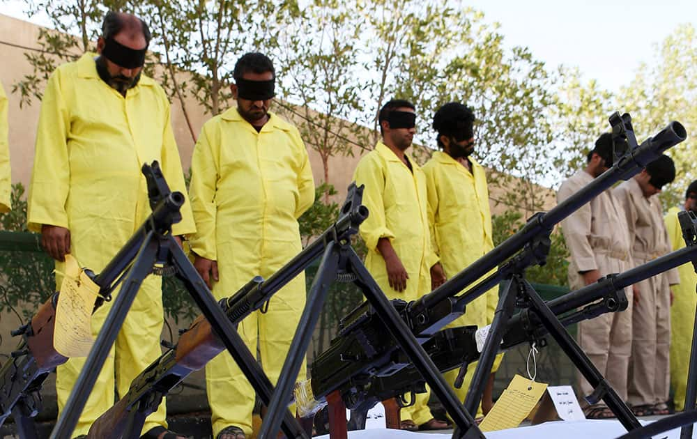 Blindfolded suspected terrorists are displayed at the federal police headquarters in Basra, Iraq. Iraq`s SWAT unit arrested 21 suspected terrorists during recent security operations in Basra, according to police.