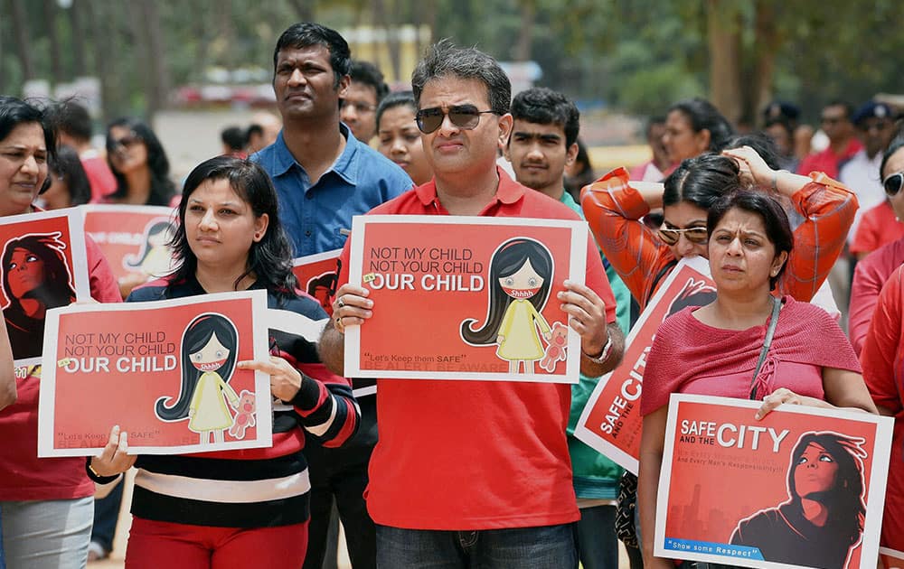 People protest over the alleged rape of a six-year-old girl in a public school at the Freedom park in Bengaluru.
