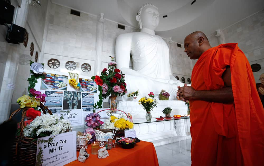 A monk prays during a special prayer for the victims of Malaysia Airlines Flight 17, Malaysia.