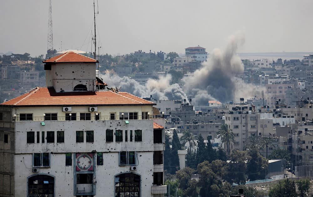 Smoke rises after an Israeli missile strike hit Gaza City. A Gaza City neighborhood came under heavy tank fire Sunday as Israel widened its ground offensive against Hamas, causing hundreds of panicked residents to flee.