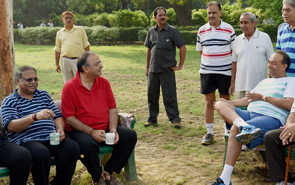 Finance and Defence Minister Arun Jaitley with newly appointed Solicitor General (SG) of India Ranjit Kumar (L) and Attorney General of India Mukul Rohatgi (sitting R) at Lodhi Garden in New Delhi.
