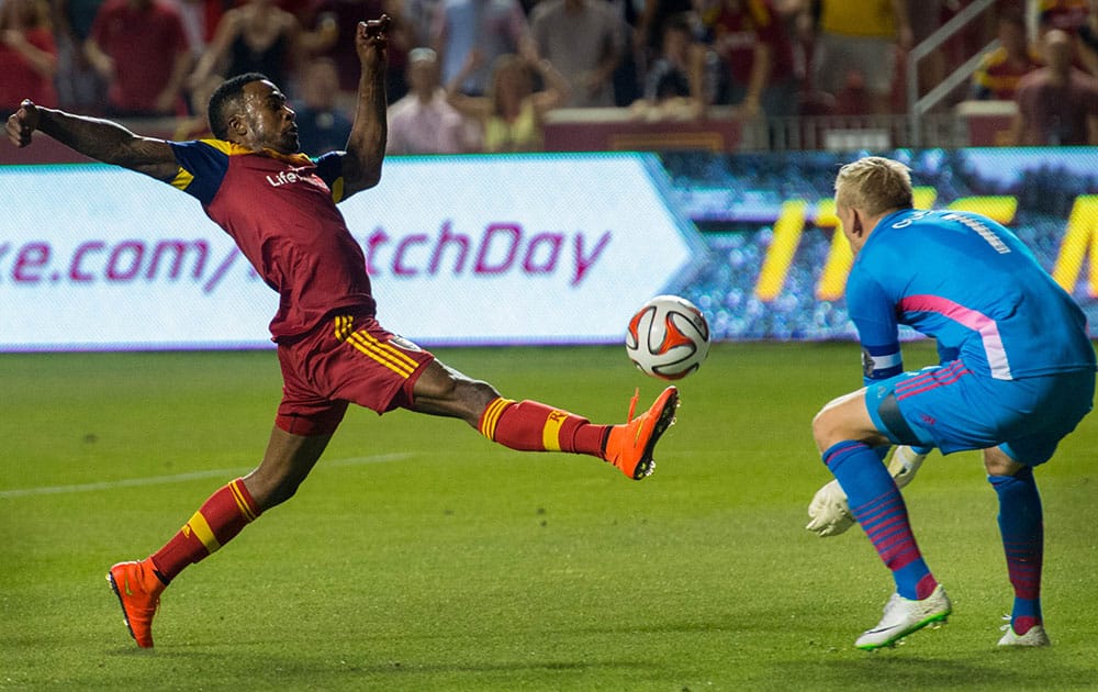 Real Salt Lake`s Robbie Findley (10) stretches for the ball in front of Vancouver Whitecaps` David Ousted (1) during an MLS soccer in Sandy, Utah. The game ended in a 1-1 tie.