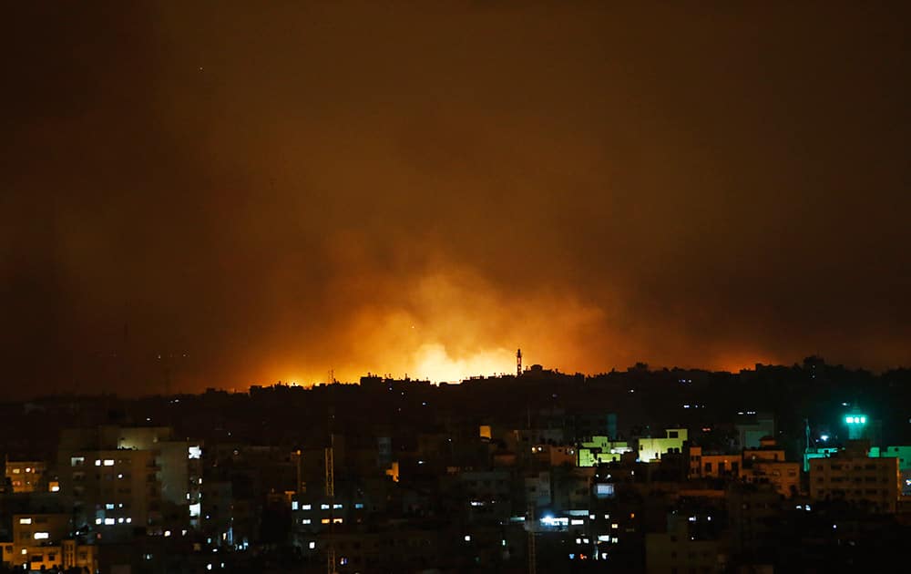 Smoke from flares fired by Israeli forces rise in the sky in Gaza City, in the northern Gaza Strip.