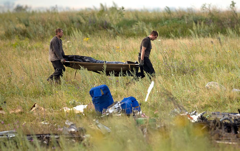 Emergency workers carry the body of a victim at the crash site of Malaysia Airlines Flight 17 near the village of Hrabove, eastern Ukraine.