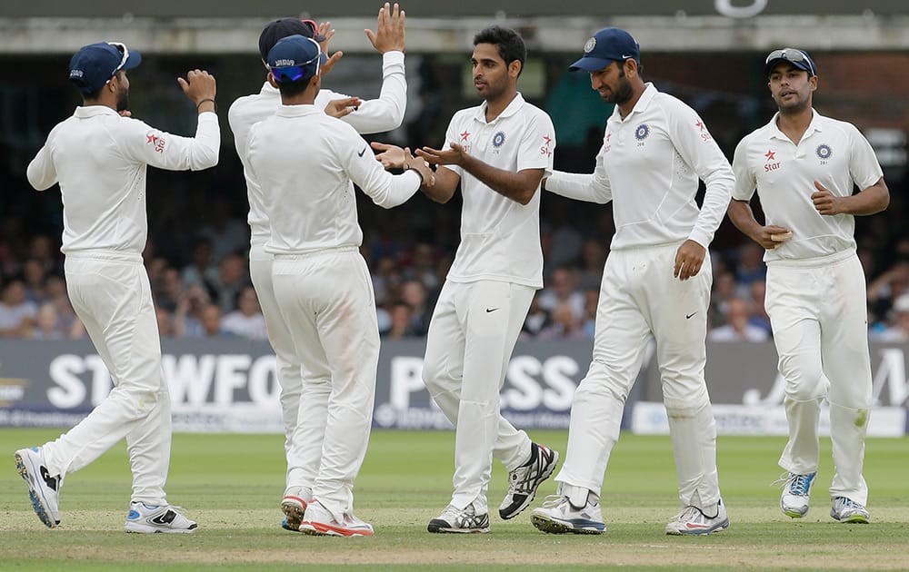 India`s players celebrate the wicket of England`s Ben Stokes during the third day of the second test match between England and India at Lord`s cricket ground in London.