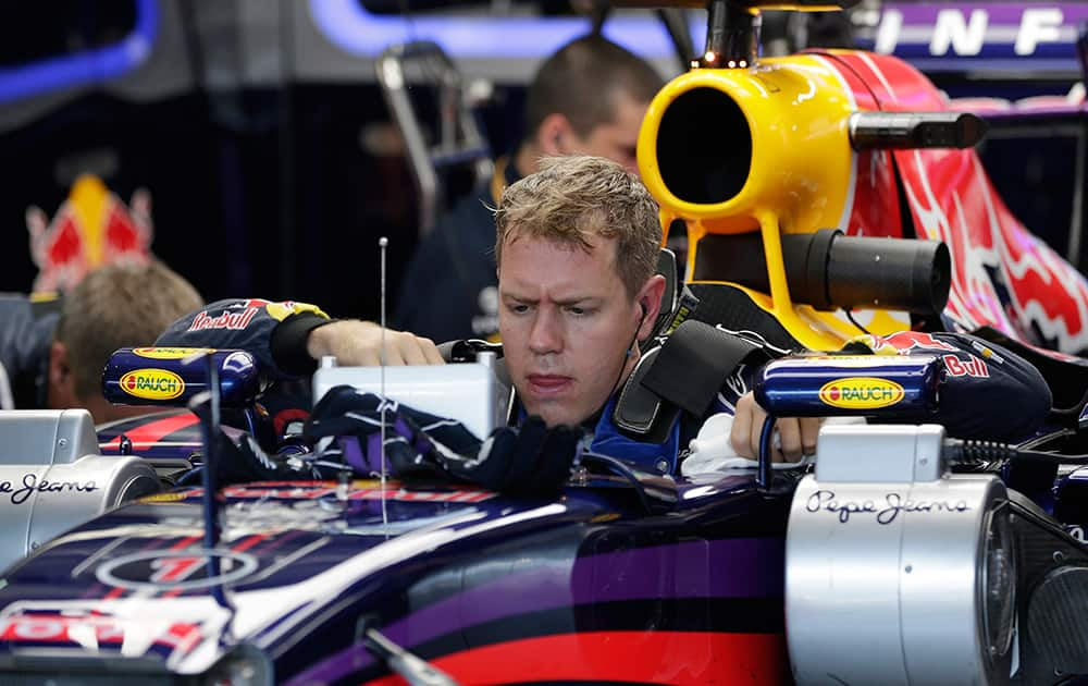 Red Bull driver Sebastian Vettel of Germany is about to leave his car during the free practice session at the German Formula One Grand Prix in Hockenheim, Germany.