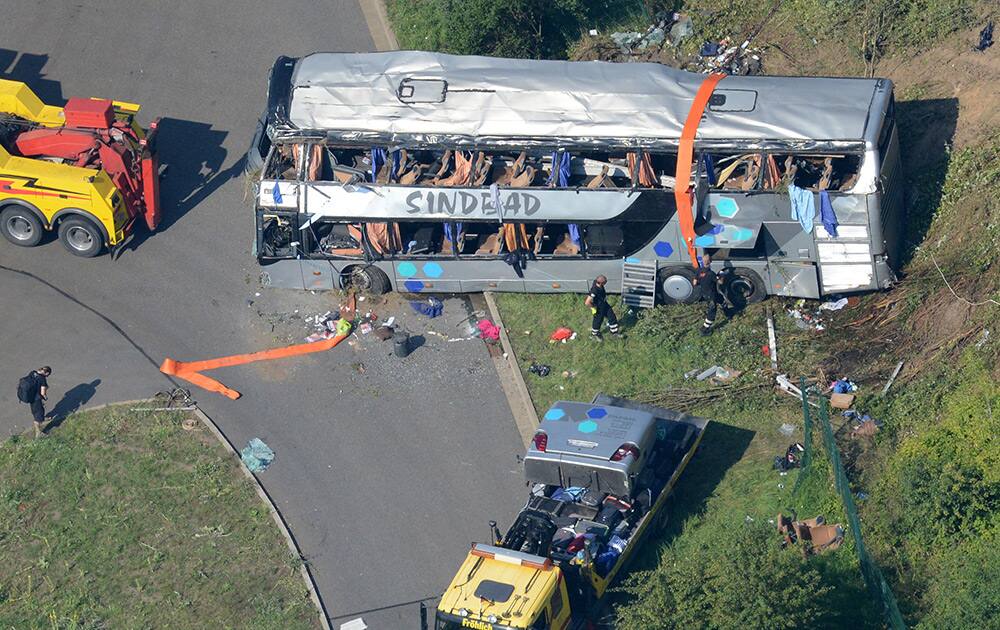 A bus wreckage and rescue vehicles stand next to the highway near Dresden, eastern Germany. Several buses crashed on the highway near the city of Dresden, leaving nine people dead and 43 injured, police said.