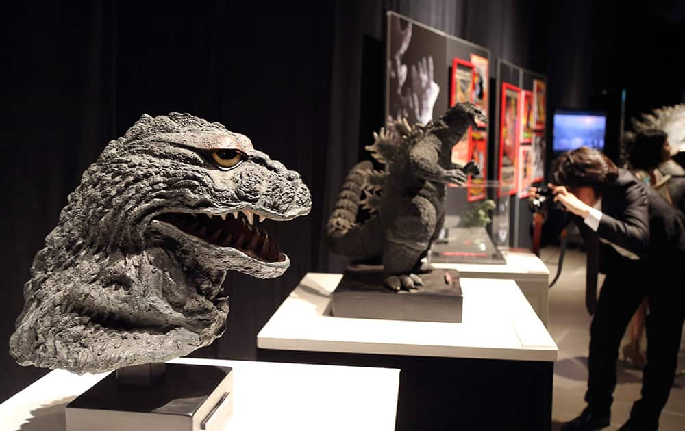 Statues of Godzilla are on display during a press preview at Godzilla Expo in Tokyo.