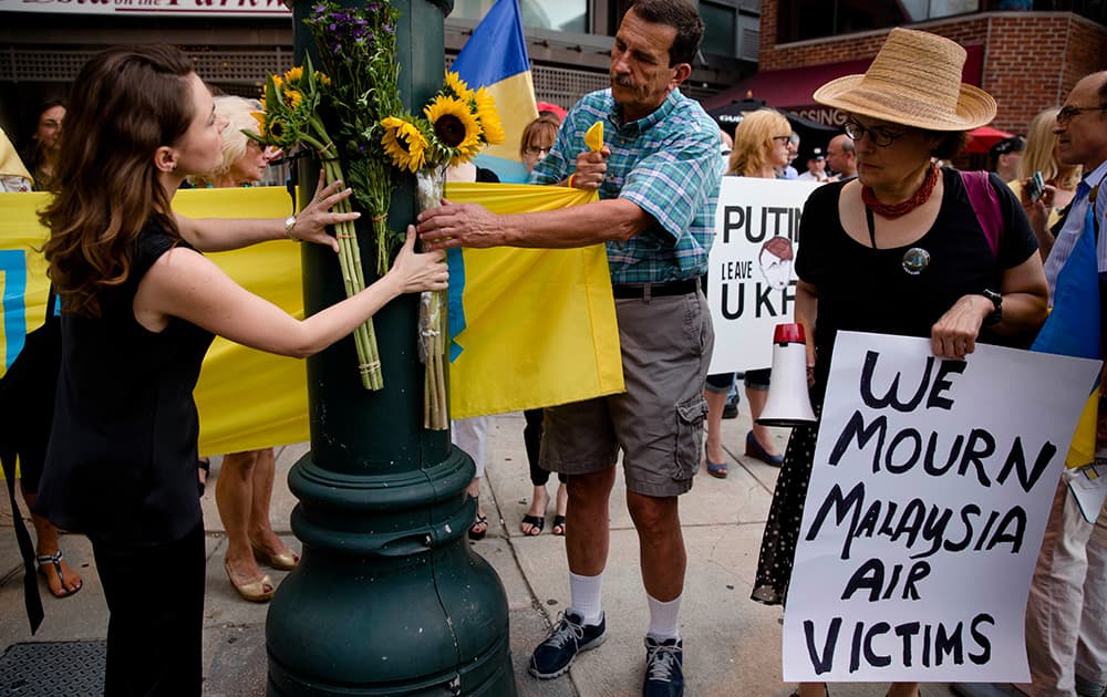 Flowers are arranged in a makeshift memorial during a vigil for victims of the Malaysia Airlines Flight 17, in Philadelphia. 