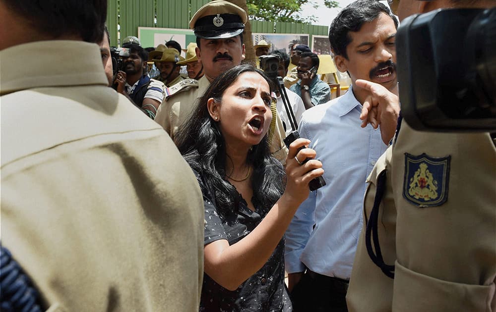 An irate guardian talks to the police officers during a protest at a school where a 6-year-girl was raped last week, in Bengaluru.