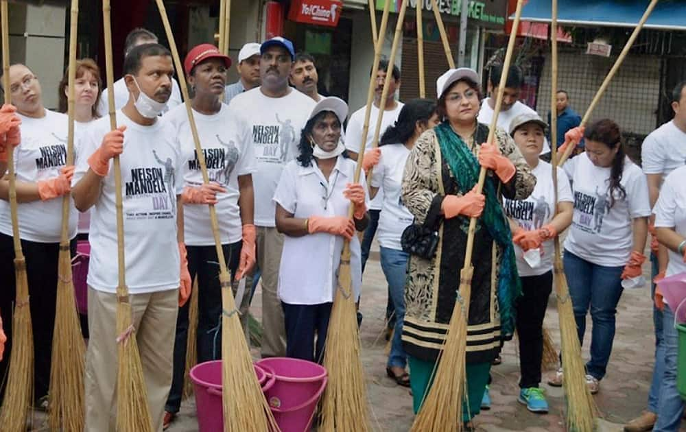 Kiran Mehra-Kerpelman, director, UN Information Centre for India and Bhutan, joins diplomats and students in volunteering to clean Basant Lok Market in Vasant Vihar, New Delhi on Nelson Mandela International Day.