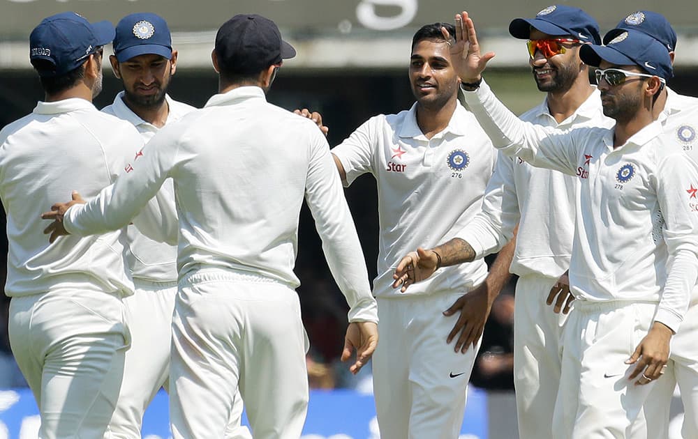 India`s players celebrate taking the wicket of England`s Sam Robson during the second day of the second test match between England and India at Lord`s cricket ground in London.