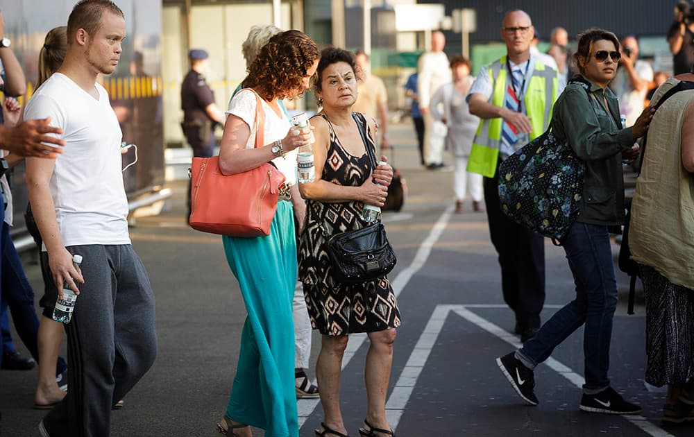 Relatives of passengers on flight MH17 walk towards a bus to be transported to an unknown location to receive more information, at Schiphol airport in Amsterdam.