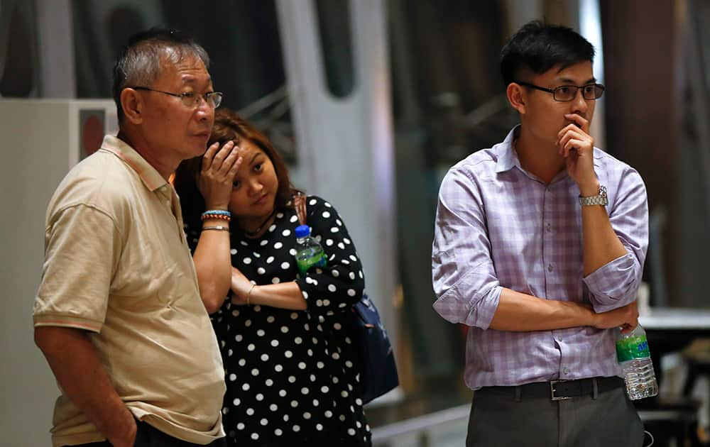 People react as they wait for news after a Malaysia Airlines plane crashed in eastern Ukraine, at Kuala Lumpur International Airport, in Sepang, Malaysia.