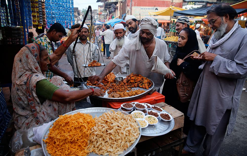 Roadside vendors sell delicacies for breaking the day-long fast during Ramadan, in Allahabad.