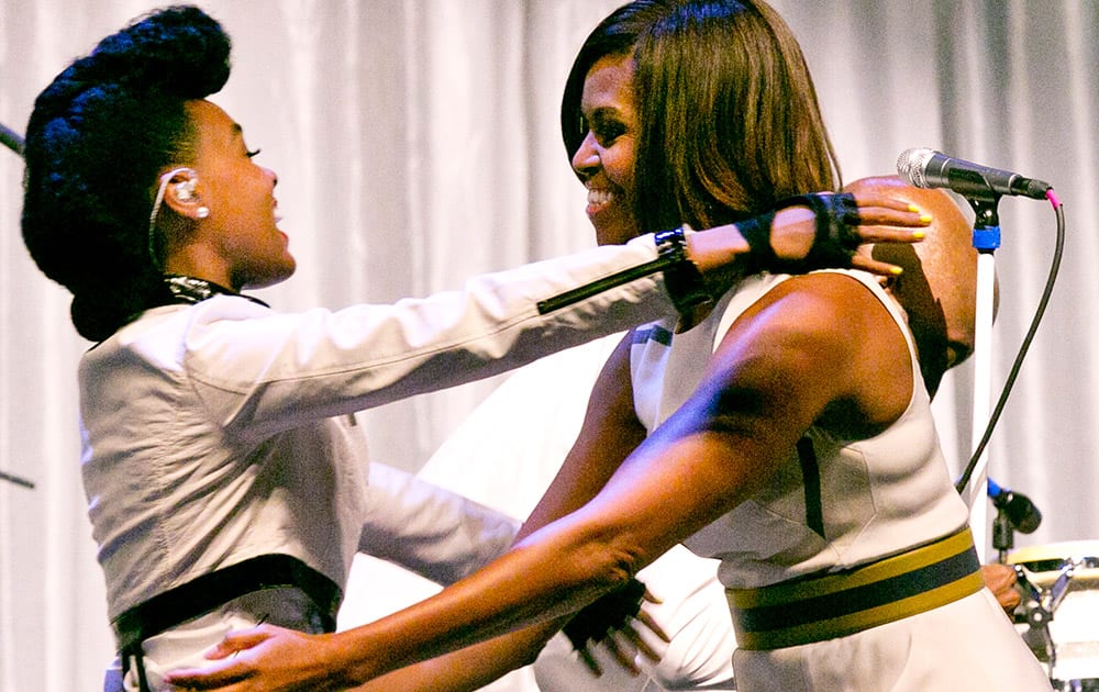 First Lady Michelle Obama, right, hugs six-time Grammy nominee singer Janelle Monae at the Grammy Museum’s Jane Ortner Education Award Luncheon in Los Angeles.