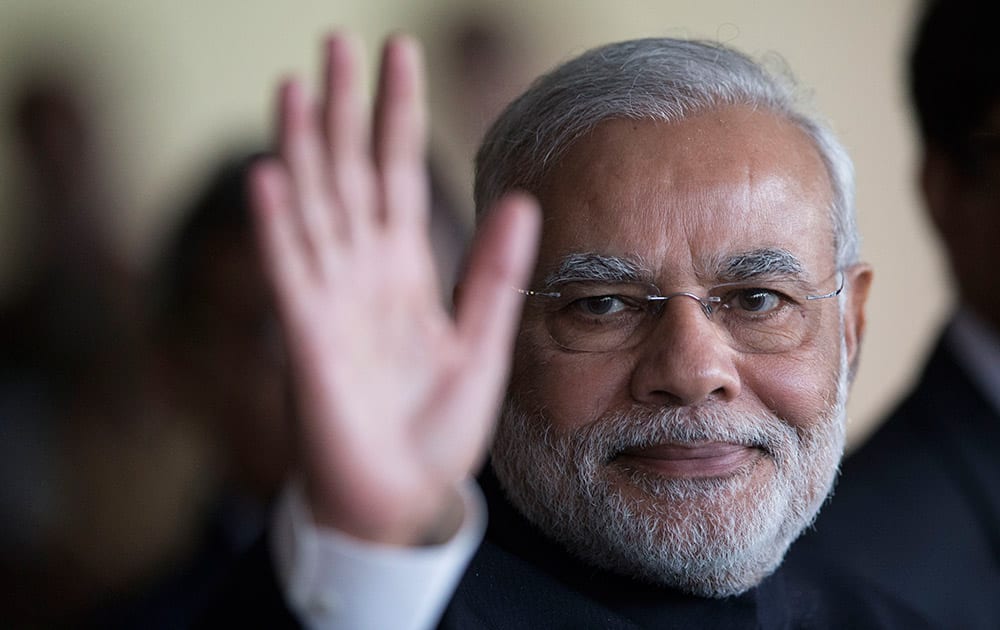 India`s Prime Minister Narendra Modi waves to photographers as he leaves the Itamaraty Palace after attending the final day of the BRICS summit in Brasilia, Brazil.