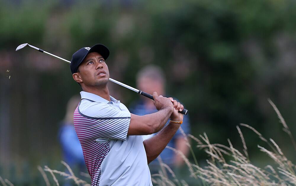 Tiger Woods of the US looks up to watch his ball on the practice chipping green ahead of the British Open Golf championship at the Royal Liverpool golf club, Hoylake, England.