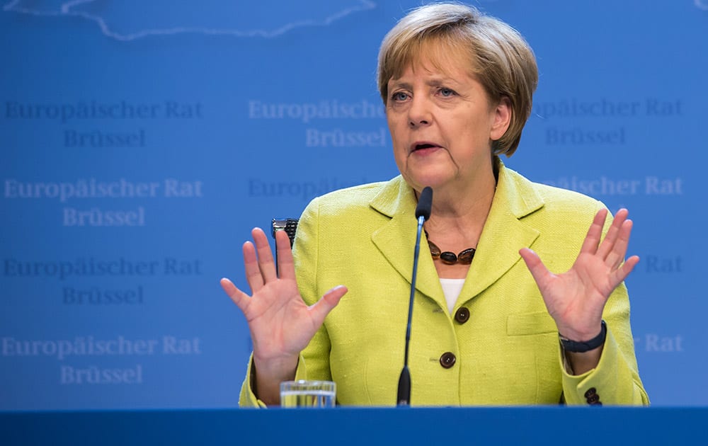 German Chancellor Angela Merkel addresses the media at the end of an EU summit at the European Council building in Brussels.